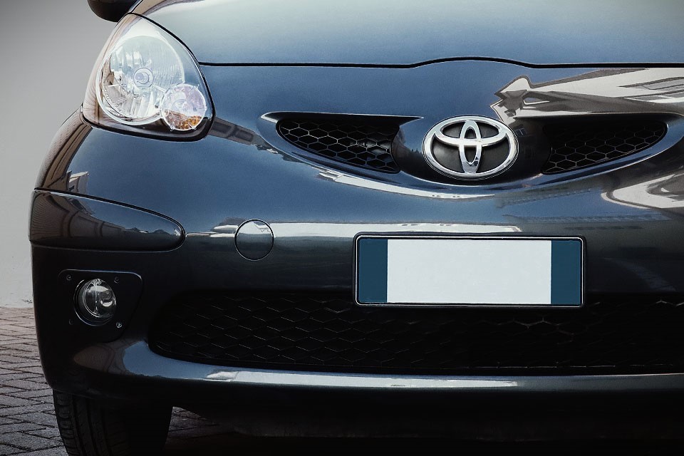 Fronten på en sort Toyota Aygo.